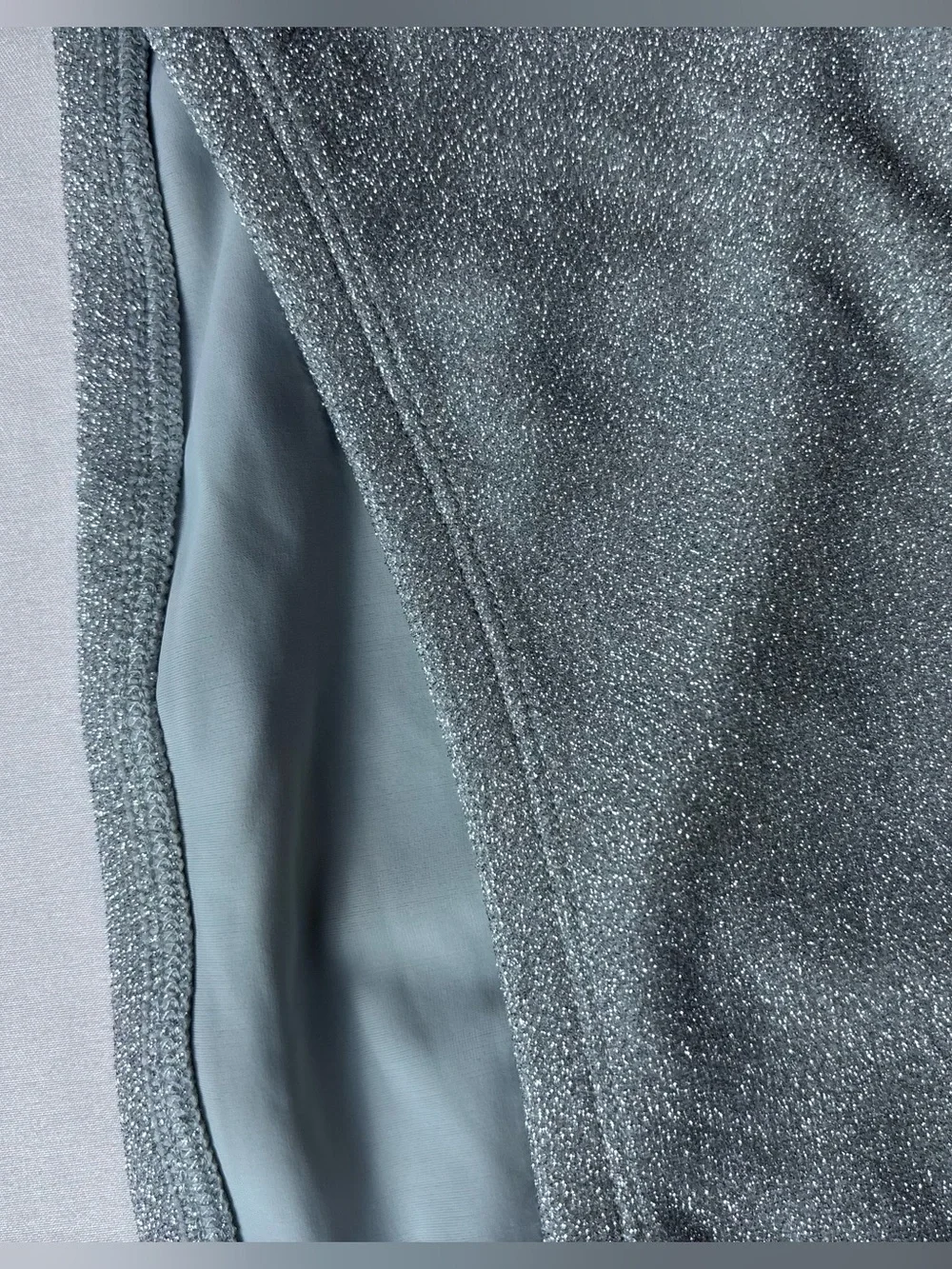 This Good American bandeau top features a shimmering silver fabric